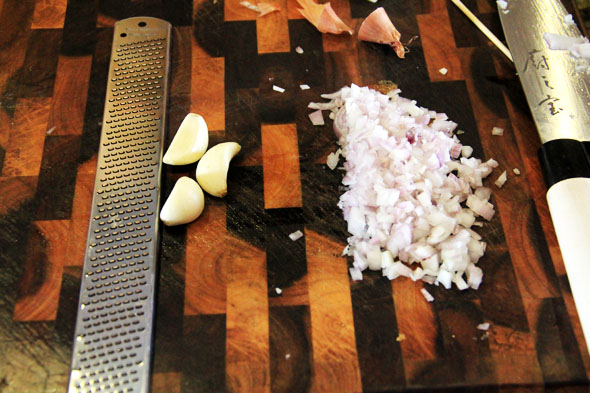 dice up your shallot, grate your garlic using a microplane (if you have one, a garlic press will also work). Set aside.