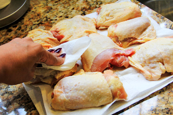 Flip the chicken over, skin-side up, and pat with a paper towel to remove any excess moisture. Too much surface moisture will prevent us from getting a nice crust.
