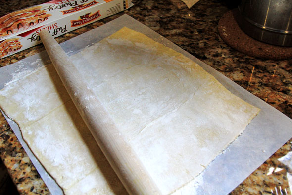 Thaw your puff pastry dough at room temperature until pliable (about a half hour, depending on the temperature in your kitchen). Flour your work surface, hands, and rolling pin and roll pastry out to a larger rectangle, making sure to connect the seams so it's all one piece.