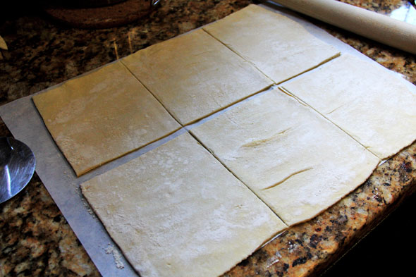With a very sharp knife or pizza cutter, cut the sheet of dough into 6 squares (if using a jumbo muffin tin, cut into 12 squares if using a regular size muffin tin). Roll each square so that it's large enough to fit into your muffin tins. 