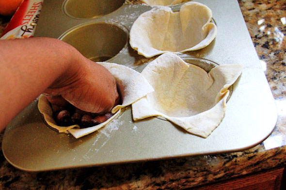 GENTLY fit each sheet of dough into the tin, careful not to rip it. Just make sure it's sitting at the bottom and pressed against the edges.