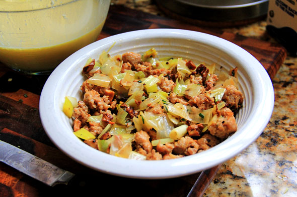 Mix the leeks, sausage and mushrooms together evenly in a bowl and let the mixture cool down for a few minutes. You don't want it too warm because it's going directly in the cold puff pastry. 