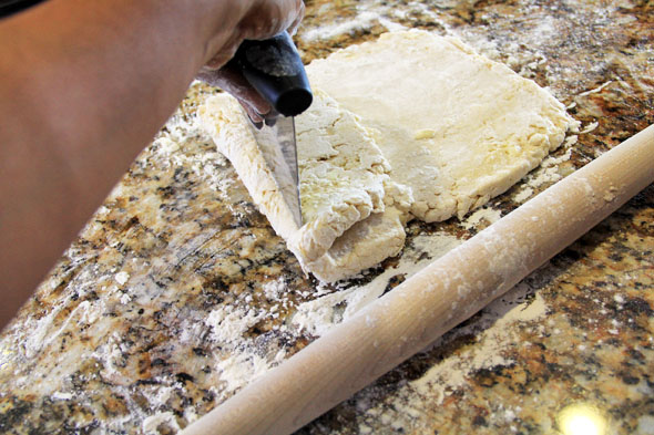 With a bench scraper (if you have one) fold over 1/3 of the dough..