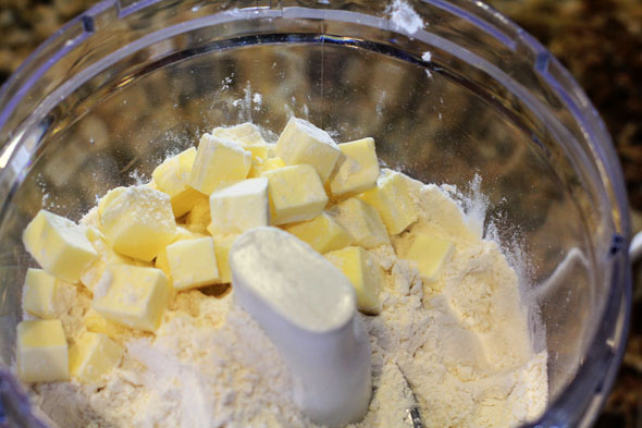 Pulse the flour, salt and baking powder. Then add the frozen cubed butter. 