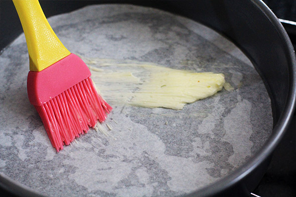 THEN butter the parchment, just a little, like a teaspoon or so. get the sides of the cake pan too.