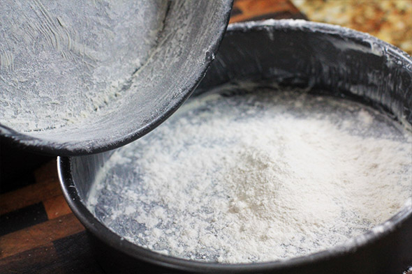 then knock all the flour out into the next pan. make sure you get as much excess flour out as you can.