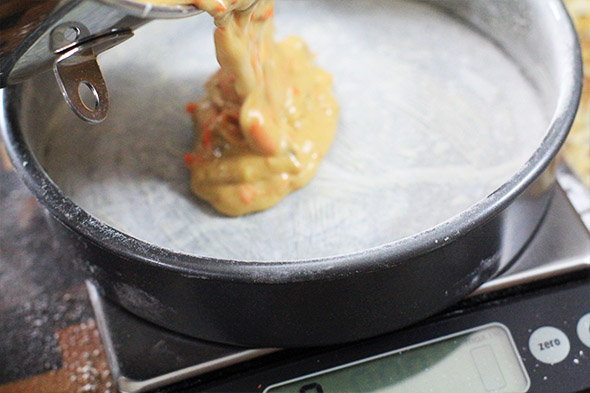 begin pouring the cake batter into each pan as evenly as possible.