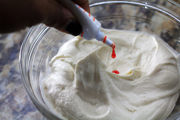 you'll have leftover frosting, you're supposed to. this cake isn't nearly complete. i'm adding some food coloring to mine because I'm extra. you do not have to do this part.