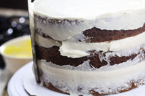 i'm giving my cake a very thin crumb coat. this will lock in any loose crumbs so that they don't appear in the final frosting.