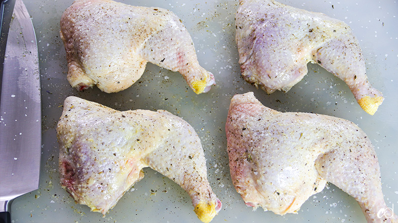 kosher salt and black pepper on raw chicken