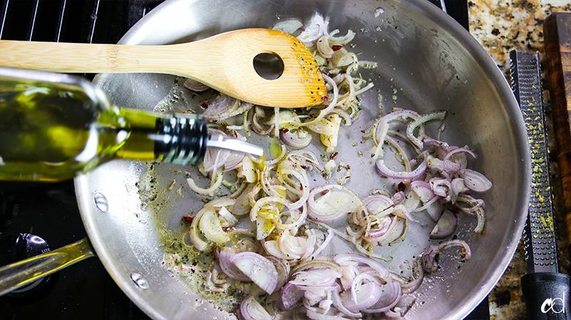 drizzling olive oil on shallots