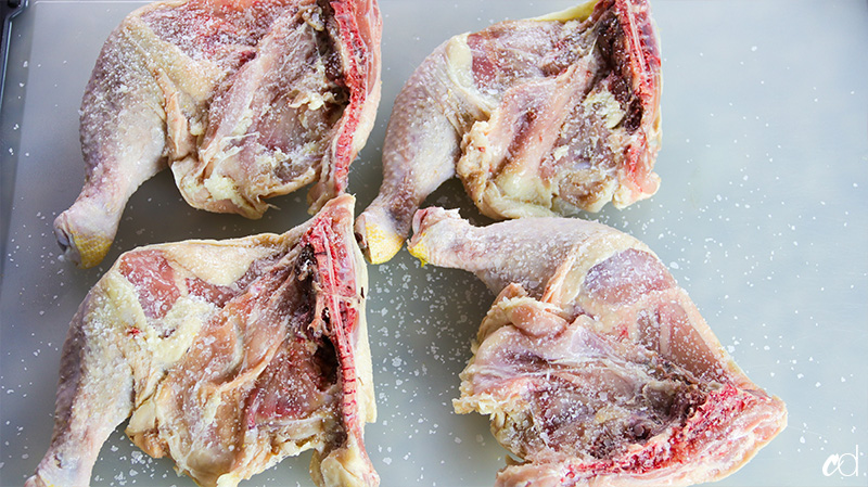 kosher salt on chicken leg quarters