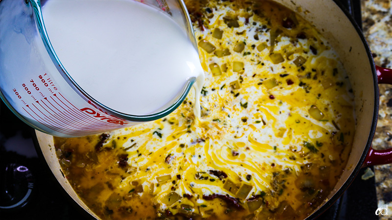 pouring chicken stock and half & half 