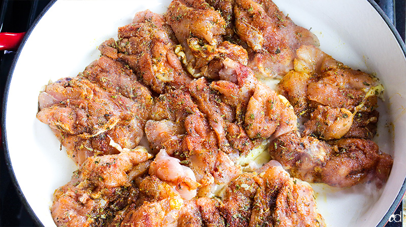 adding chicken thighs to dry pan