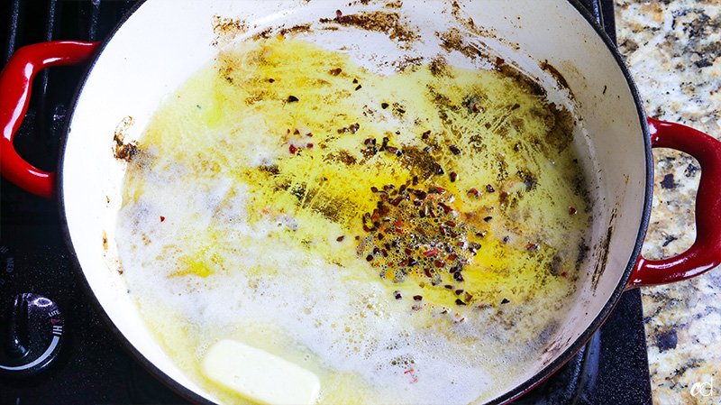 melting butter over heat with crushed red pepper flakes