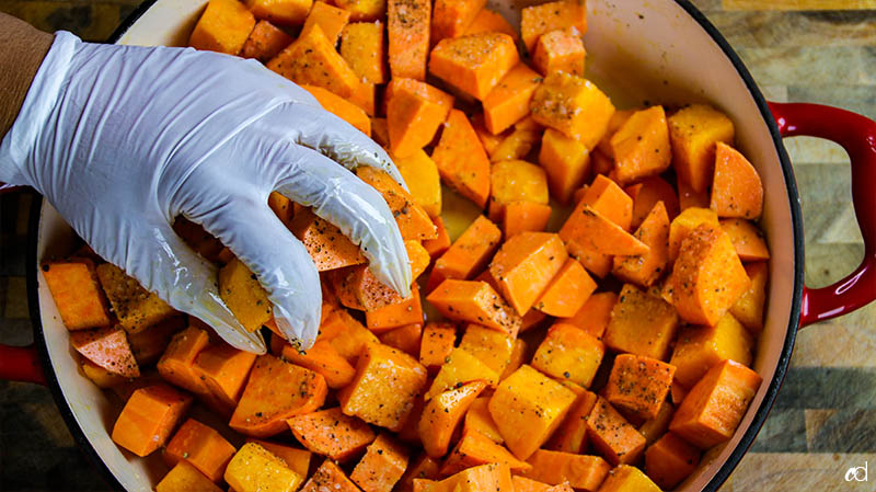 adding salt and pepper to sweet potatoes and butternut squash