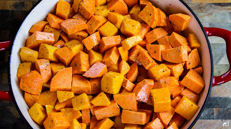 adding salt and pepper to sweet potatoes and butternut squash