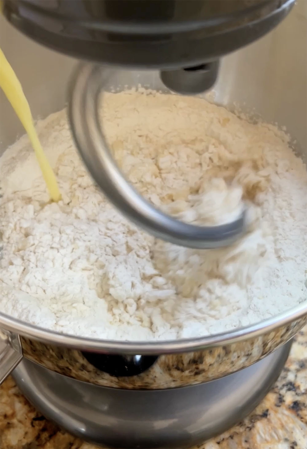adding egg and water mixture to flour and yeast