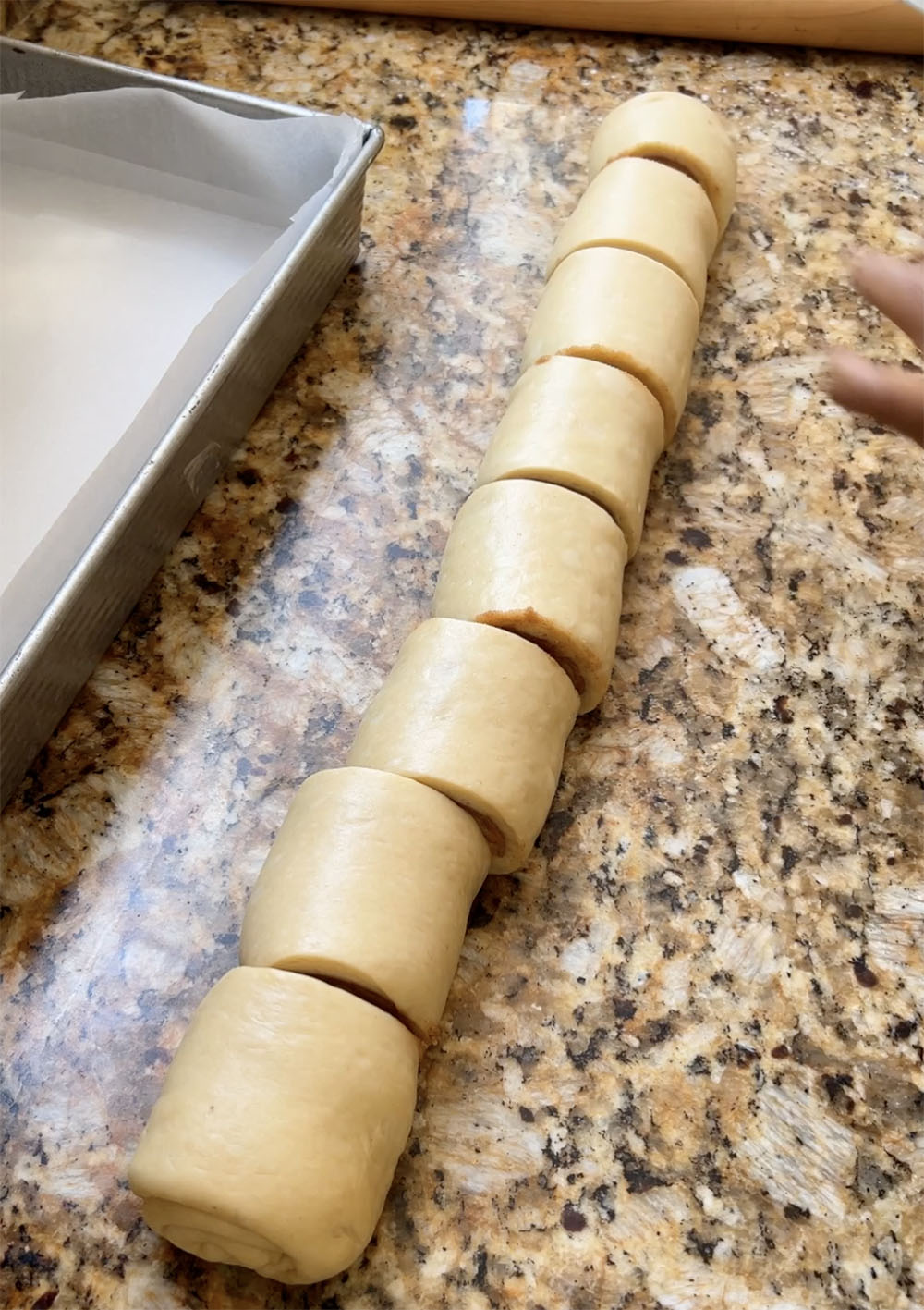 cutting the cinnamon rolls