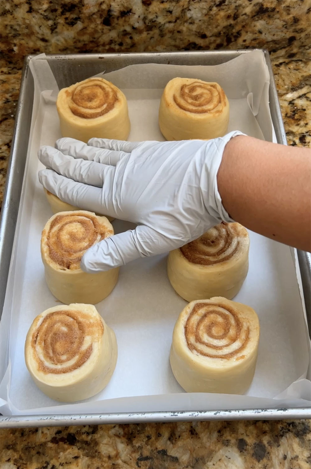 gently pressing the rolls down